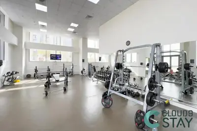 a gym with a large room with several machines at Cloud 9 - Luxurious 1 Bedroom Apartment in Business Bay in Dubai