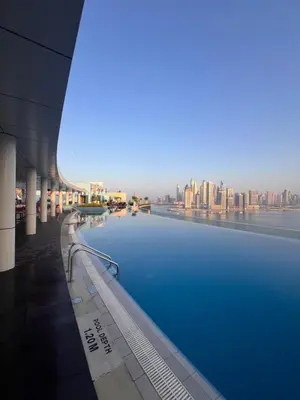 a view of a large swimming pool in a building at Charming Studio in Seven Palm with Balcony Rooftop Floor in Dubai