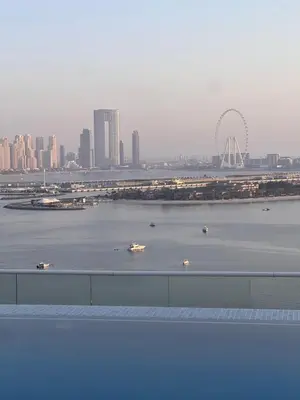 a view of a river with boats in a city at Charming Studio in Seven Palm with Balcony Rooftop Floor in Dubai