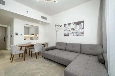a living room with a couch and a table at Chic 1 Bed in Creek Side with Terrace in Dubai