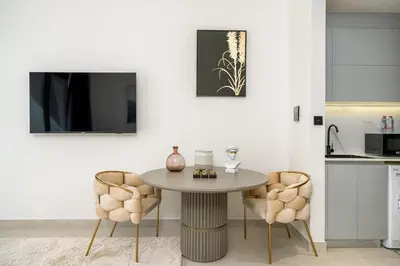 a kitchen with a table and two chairs at Business Bay Studio Binghatti Canal with Terrace in Dubai