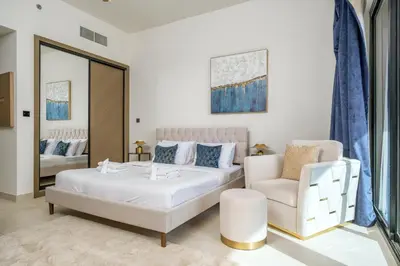 a bedroom with a bed and a couch and a chair at Business Bay Studio Binghatti Canal with Terrace in Dubai