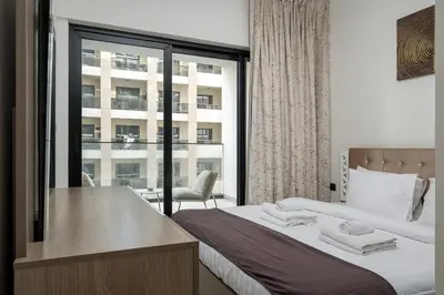 a bedroom with a bed and a large window at Elegant 1 Bed Apartment in Binghatti Creek in Dubai