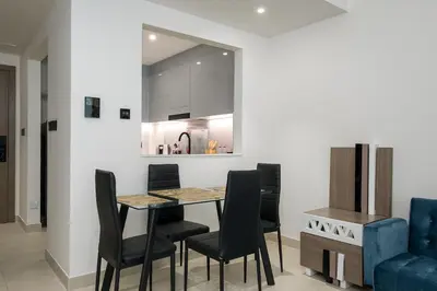 a kitchen and dining room with a table and chairs at Elegant 1 Bed Apartment in Binghatti Creek in Dubai