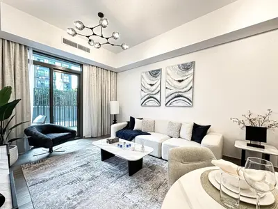 a living room with a couch and a table at Super Spacious 2BR with Designer Touch in Dubai