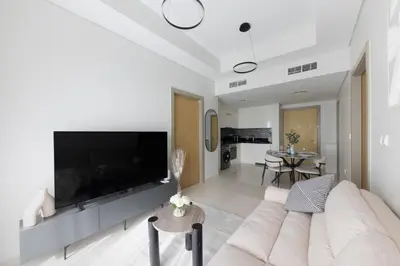 a living room with a large flat screen tv at Cozy 2BR in Business Bay, Aykon Tower in Dubai