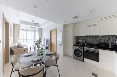 a kitchen and dining room with a table and chairs at Cozy 2BR in Business Bay, Aykon Tower in Dubai