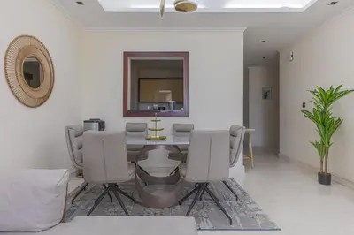 a dining room with a table and chairs at Spacious New 2 BDR, Pool and Beach Access in Dubai