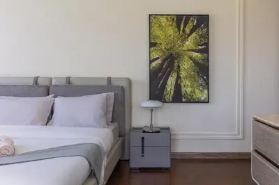 a bedroom with a bed and a picture on the wall at Spacious New 2 BDR, Pool and Beach Access in Dubai