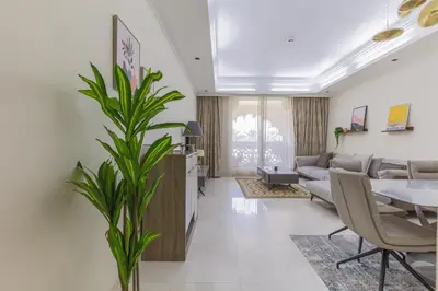 a living room with a couch and a table at Spacious New 2 BDR, Pool and Beach Access in Dubai