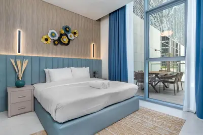 a bedroom with a large bed and a dining room at Luxury apartment in Dubai center, District One in Dubai