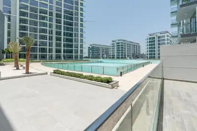 a swimming pool on the roof of a building with tall buildings at Luxury apartment in Dubai center, District One in Dubai