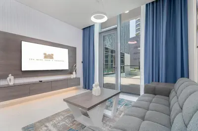 a living room with a couch and a tv at Luxury apartment in Dubai center, District One in Dubai