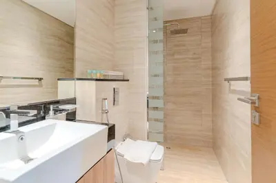 a bathroom with a white sink and a shower at DAYF-DAN Missoni Apartment with Private Lift in Business Bay in Dubai