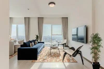 a living room with a blue couch and chairs at DAYF-DAN Missoni Apartment with Private Lift in Business Bay in Dubai