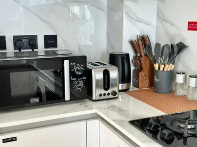 a kitchen with a toaster oven and a microwave at Gorgeous 1br Apt In Jvc in Dubai
