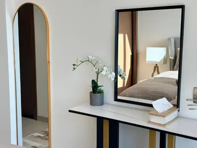 a mirror sitting on a shelf next to a bedroom at Gorgeous 1br Apt In Jvc in Dubai