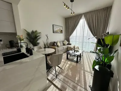 a living room with a couch and a table at Gorgeous 1br Apt In Jvc in Dubai
