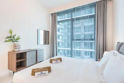 a hotel room with a bed and a large window at Stunning Beachfront Home with Panoramic Sea Views in Dubai