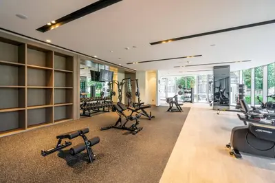 a gym with several treadmills and exercise equipment at GuestReady - Burj Khalifa View l Infinity Pool in Dubai