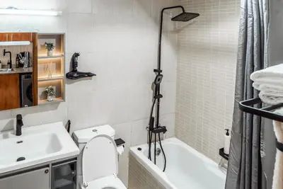 a bathroom with a toilet and a sink and a shower at Studio in Dubai Pool, Gym & Stunning Views in Dubai