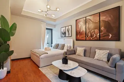 a living room with a couch and a table at Luxury JLT Studio Lake View Metro & Marina in Dubai