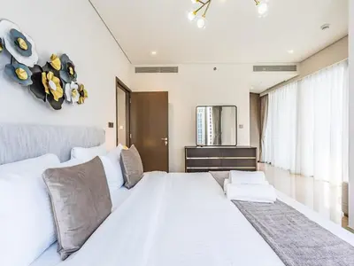a bedroom with a large white bed with white pillows at 2 BR - Grande Signature - Burj Khalifa View in Dubai