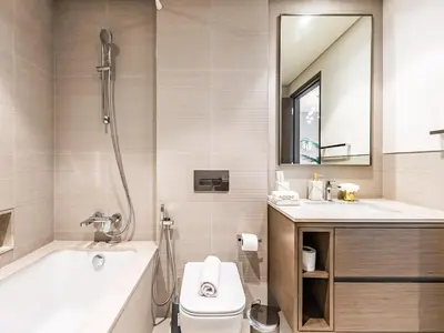 a bathroom with a tub and a toilet and a sink at 2 BR - Grande Signature - Burj Khalifa View in Dubai