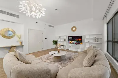 a living room with a couch and a table at Elegant 2BR with Seaview in JBR l Walk to the Beach in Dubai