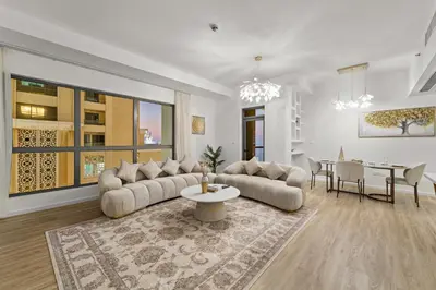a living room with two couches and a table at Elegant 2BR with Seaview in JBR l Walk to the Beach in Dubai