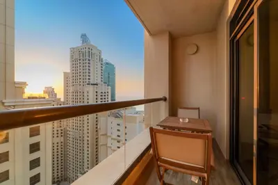 a balcony with a view of a city at Elegant 2BR with Seaview in JBR l Walk to the Beach in Dubai