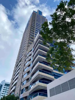 a tall building with a tree in front of it at Lovely Studio in Dubai Marina near Beach and Metro Z417 in Dubai