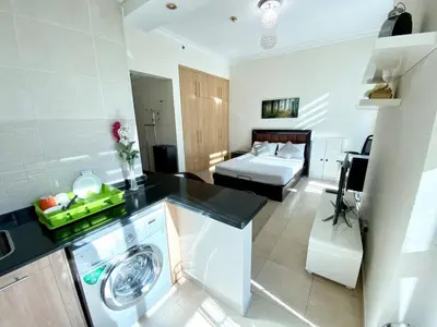 a kitchen and living room with a washer and dryer at Lovely Studio in Dubai Marina near Beach and Metro Z417 in Dubai