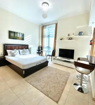 a large bedroom with a bed and a television at Lovely Studio in Dubai Marina near Beach and Metro Z417 in Dubai