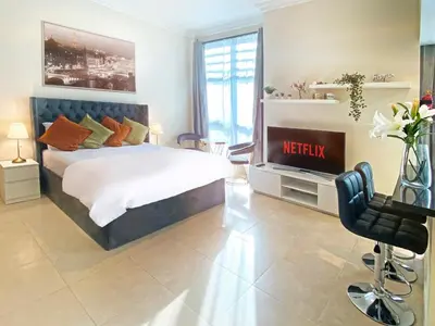 a bedroom with a bed and a television in it at Elegant Studio in Marina near Beach and Metro Z1113 in Dubai