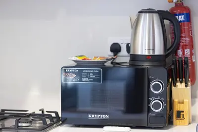 a toaster oven and a microwave next to a stove at Exclusive 1-Bedroom Apartment with Breathtaking Burj Khalifa Views in the Heart of Dubai in Dubai