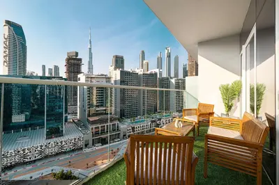 a balcony with chairs and a view of the city at Exclusive 1-Bedroom Apartment with Breathtaking Burj Khalifa Views in the Heart of Dubai in Dubai