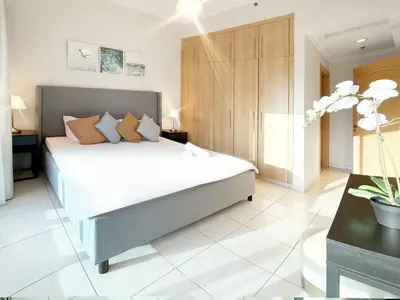 a bedroom with a large bed in a room at Cozy 1 Bedroom Apartment with Marina and Sea View Z1306 in Dubai