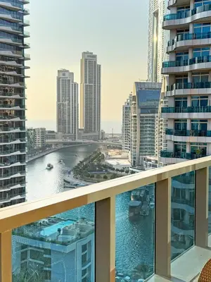 a view of a river from a balcony in a city at Cozy 1 Bedroom Apartment with Marina and Sea View Z1306 in Dubai