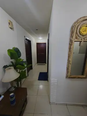 a hallway with a mirror on the wall and a table at Private Master Room Marina Beach next to Marriott in Dubai
