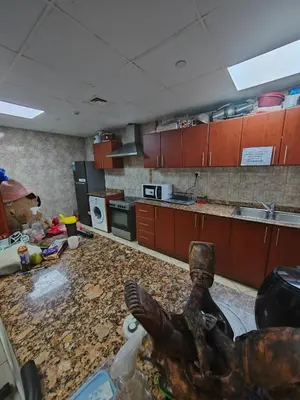 a messy kitchen with a statue in the middle of it at Private Master Room Marina Beach next to Marriott in Dubai