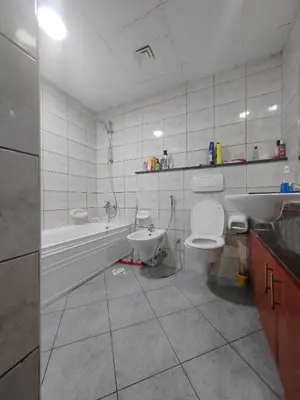 a bathroom with a toilet and a tub and a sink at Private Master Room Marina Beach next to Marriott in Dubai