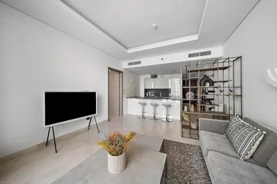 a living room with a tv and a couch at Luxury Living in Sterling West in Dubai