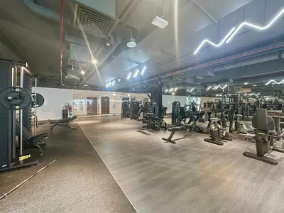 a gym with lots of treadmills and machines in it at Luxury Living in Sterling West in Dubai