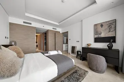 a bedroom with a large bed and a desk at Luxury Living in Sterling West in Dubai