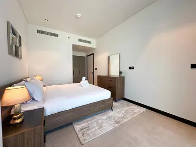 a bedroom with a bed and a dresser and a mirror at Luxury 1BR in 15 Northside Tower with Canal View 4AB03 in Dubai