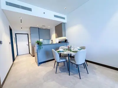 a kitchen and dining room with a table and chairs at Luxury 1BR in 15 Northside Tower with Canal View 4AB03 in Dubai