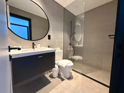 a bathroom with a sink and a toilet and a mirror at Luxury 1BR in 15 Northside Tower with Canal View 4AB03 in Dubai