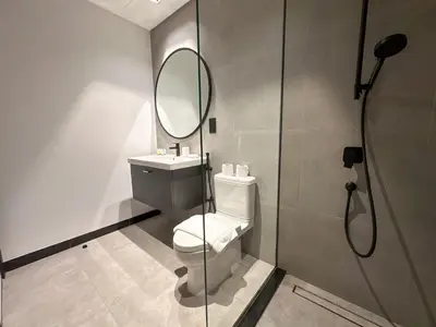 a bathroom with a toilet and a mirror at Luxury 1BR in 15 Northside Tower with Canal View 4AB03 in Dubai