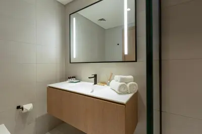a bathroom with a sink and a mirror at Burj & Beyond - Luxury Stay with Burj Khalifa View in Dubai